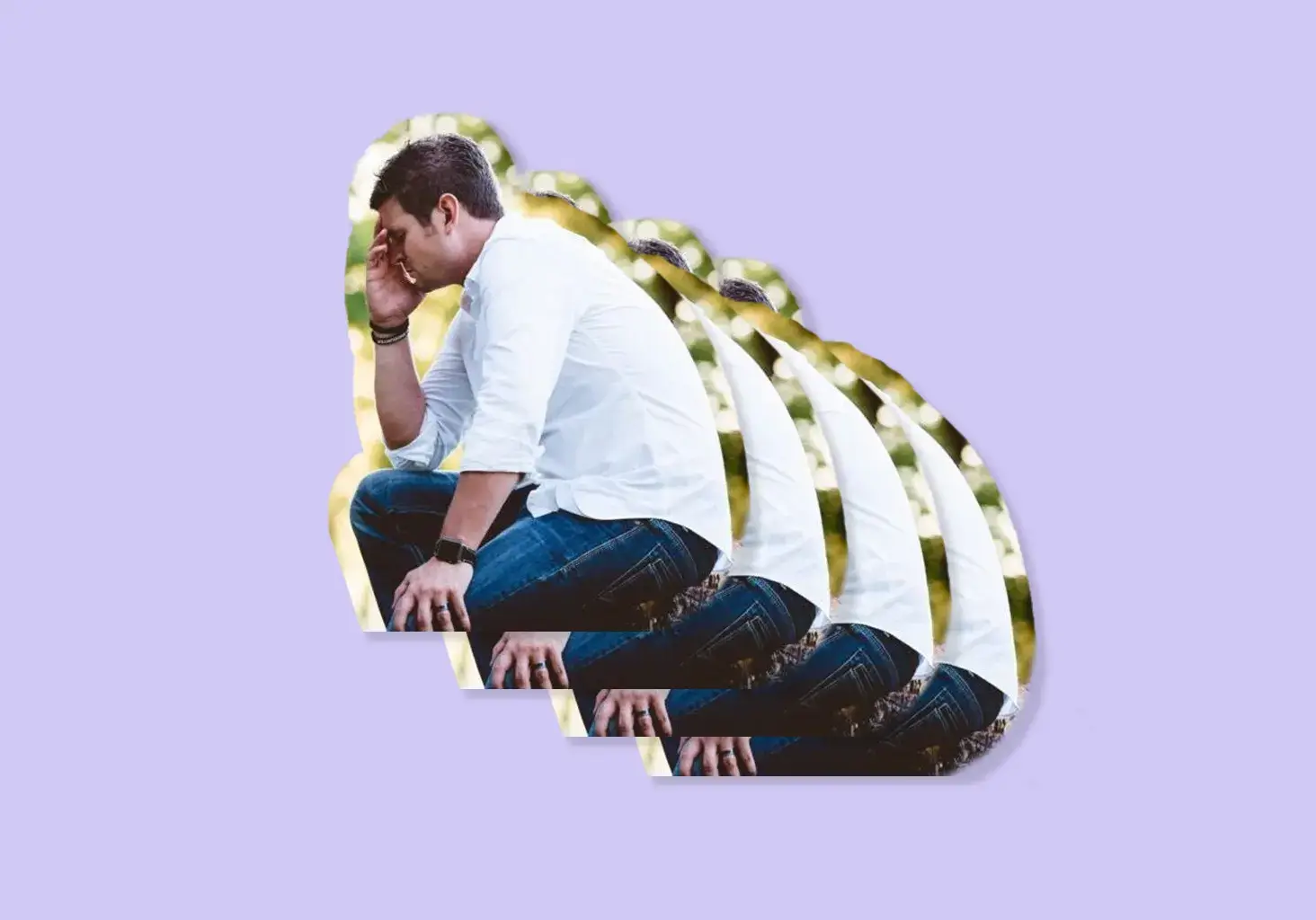 a man sitting down with his hand on his face