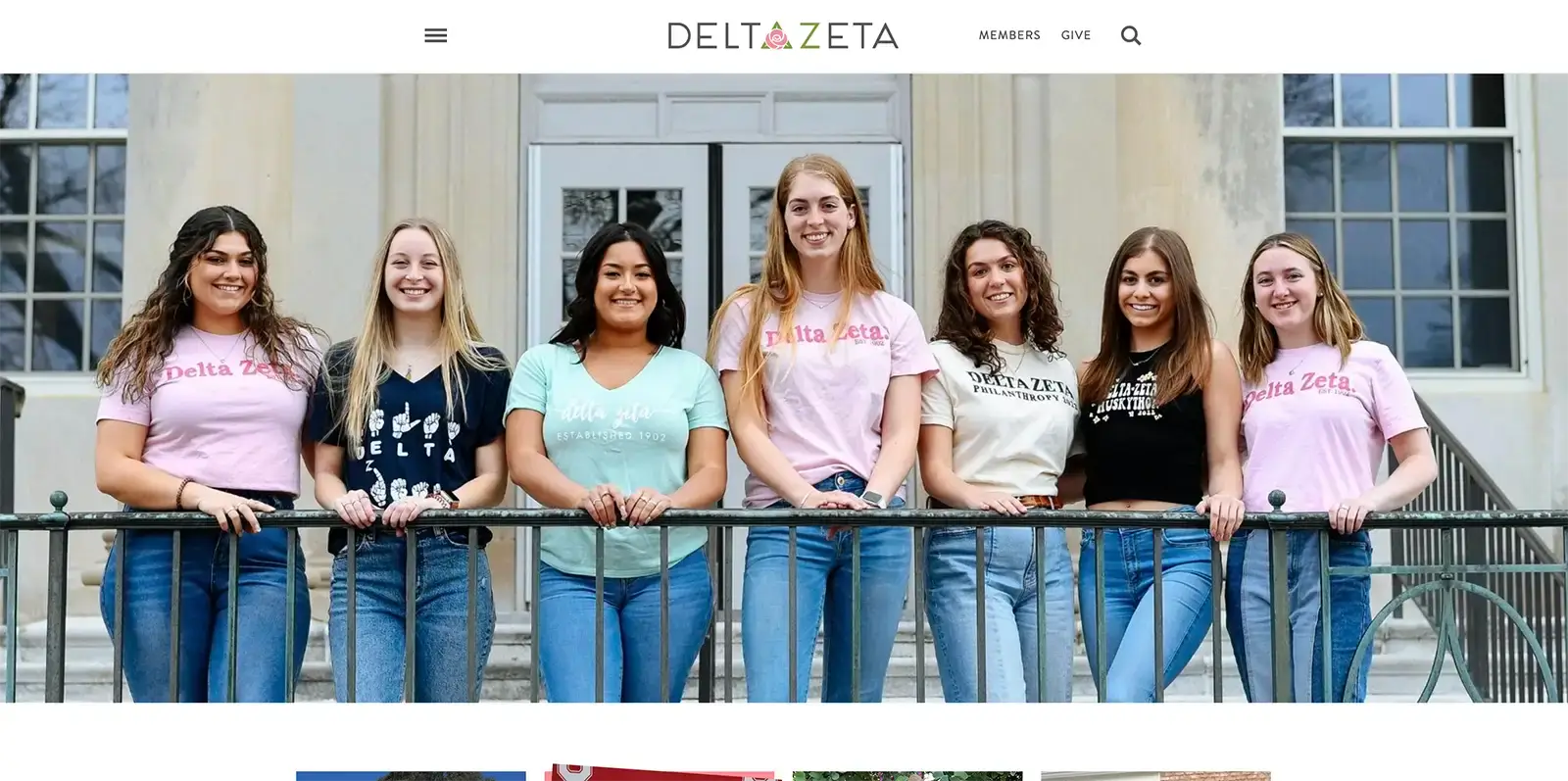 a group of women standing on a railing