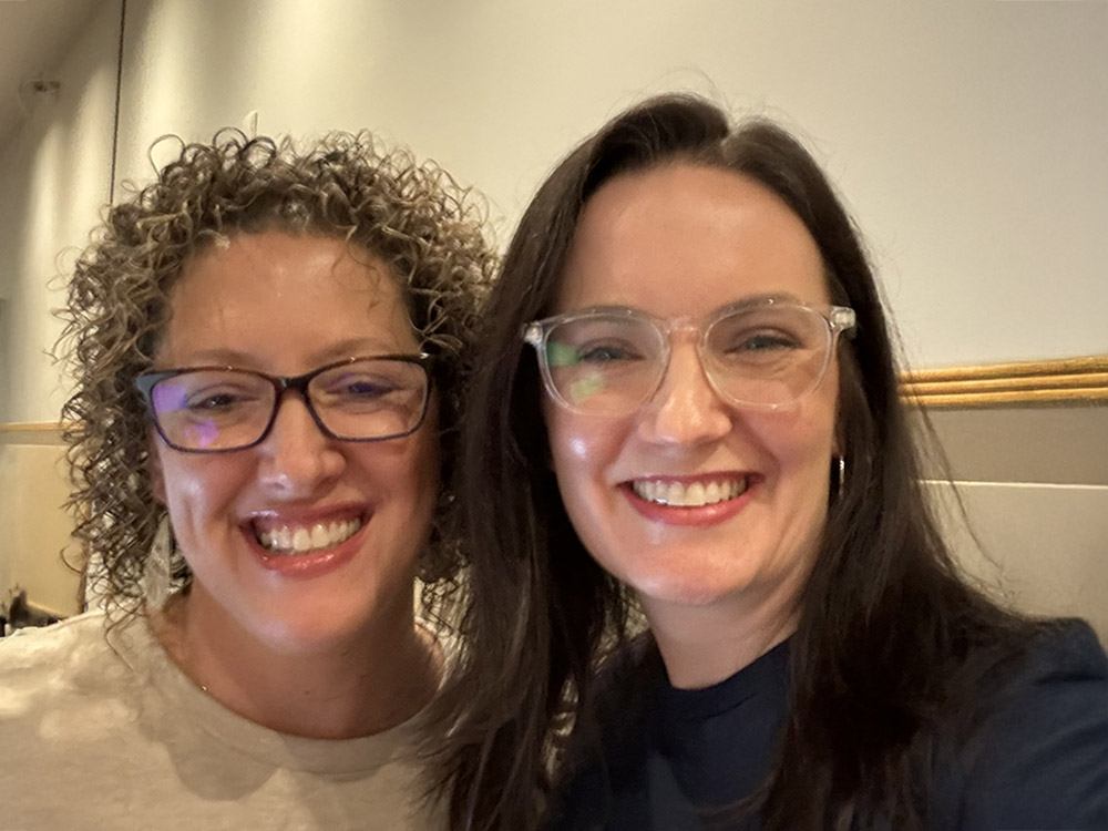 Gina Deaton and friend smiling together in a close-up photo, capturing their collaboration at WordCamp US 2024.